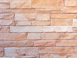 色褪せた暖色系レンガ壁のテクスチャー